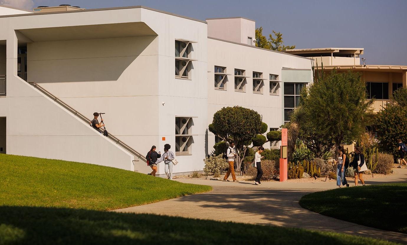 several students leave broad hall building after class